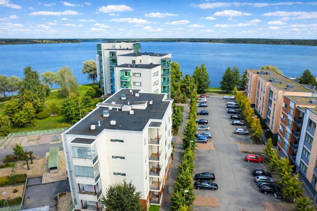 an aerial view of a parking lot with buildings and the water at Lutakko Stay with Sauna, Parking & Self Check-in in Jyväskylä