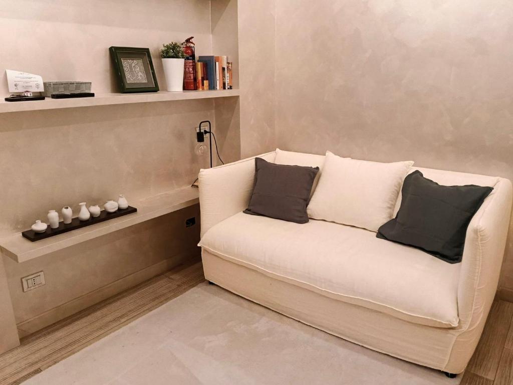 a white couch with two pillows in a living room at La Casina in Terminillo