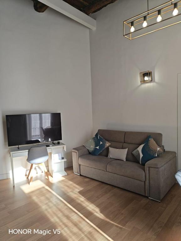 a living room with a couch and a flat screen tv at La Dimora di Tuya Superior in Naples