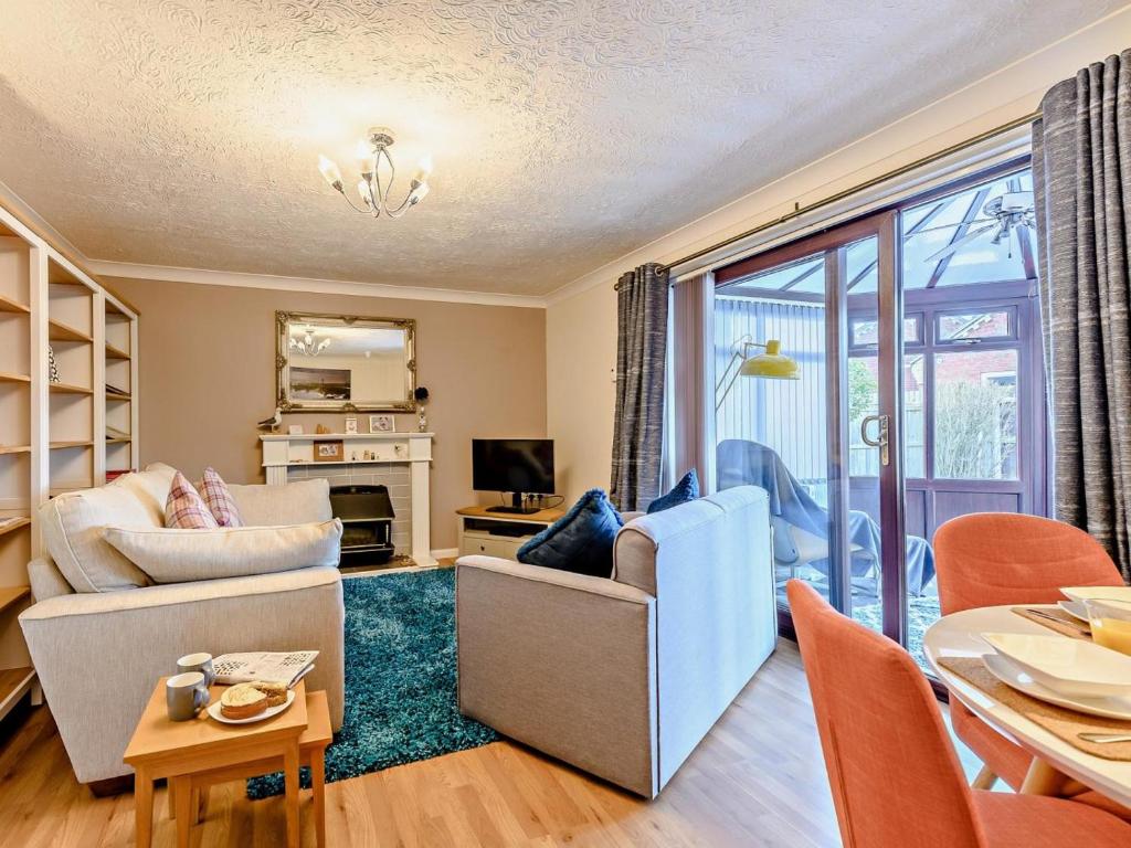 a living room with a couch and a table at 2 Bed in Mablethorpe oc-80703 in Sutton on Sea