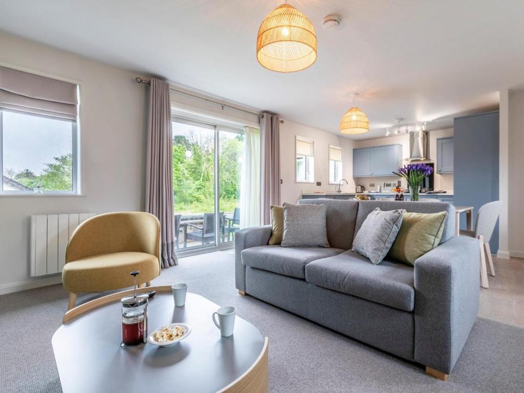 a living room with a couch and a table at 2 Bed in Saltash oc-87709 in St. Mellion