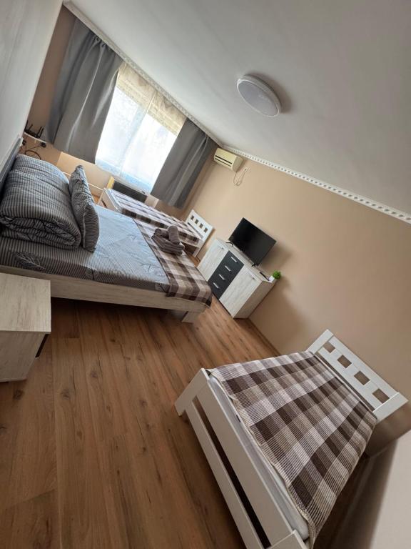 a small bedroom with a bed and a window at Panorama Spa Apartment in Berehove