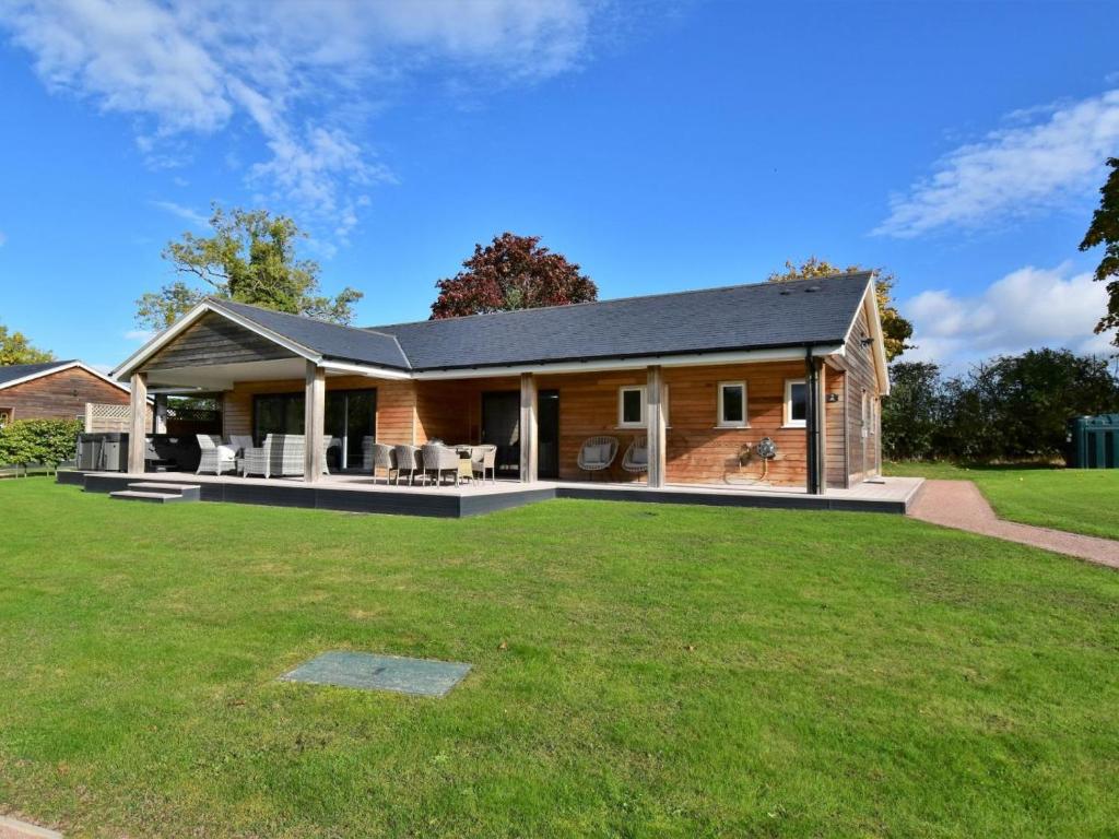 a house with a large lawn in front of it at 4 Bed in Oswestry oc-74110 in Kinnerley