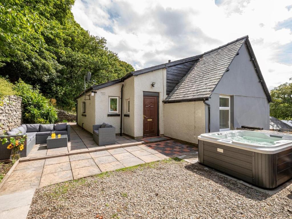 a small house with a hot tub in the yard at 4 Bed in Bala oc-75288 in Llandderfel
