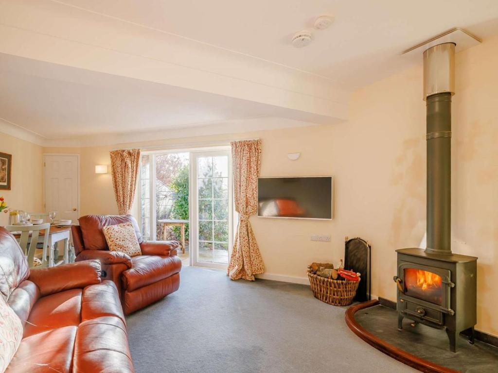 a living room with a couch and a wood stove at 2 Bed in Wrexham oc-43916 in Overton