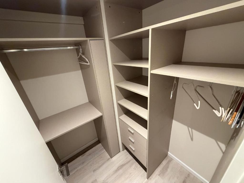 a walk in closet with gray walls and white shelves at Deco Recoleta in Buenos Aires