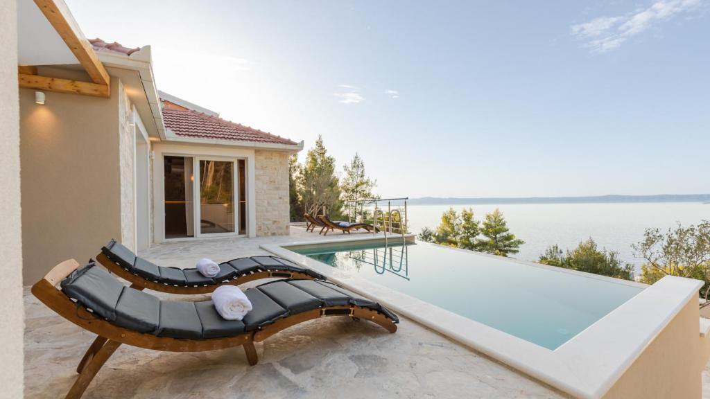 a villa with a swimming pool and a house at Villa Silvana by Villas Guide in Blato