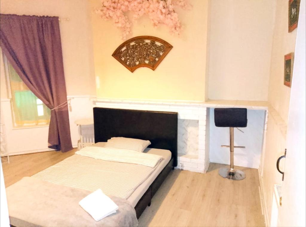 a bedroom with two beds and a television in it at Central Simple Cambridge stay in Cambridge