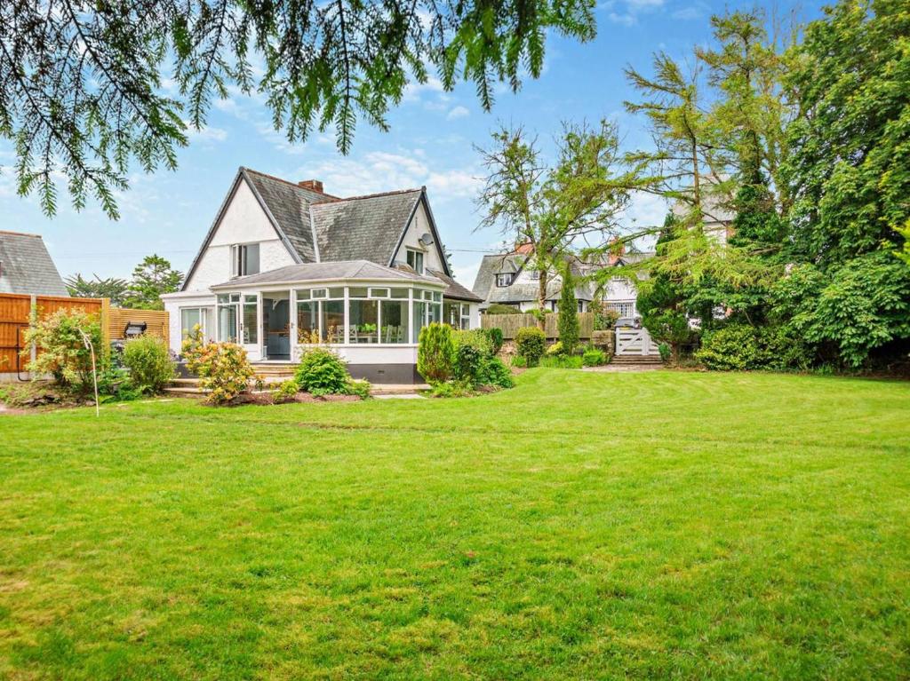 a house with a large yard with green grass at 4 Bed in Beaumaris oc-94501 in Llanddona