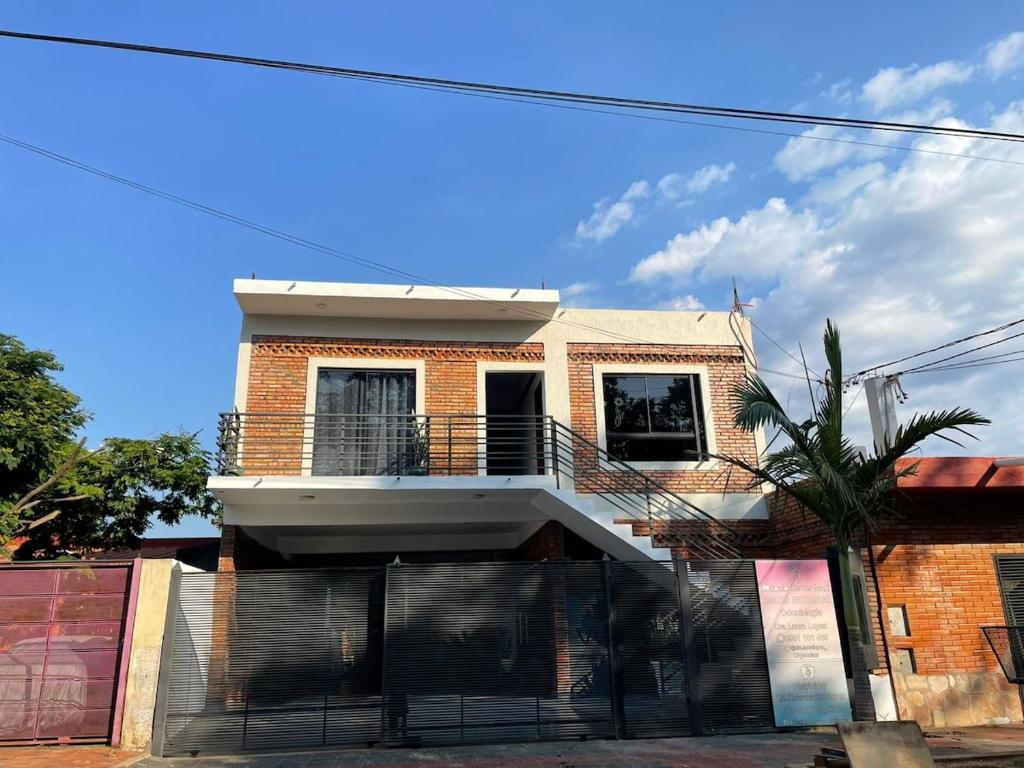 a brick house with a balcony on top of it at Apartamento minimalista con balcón in Fernando de la Mora