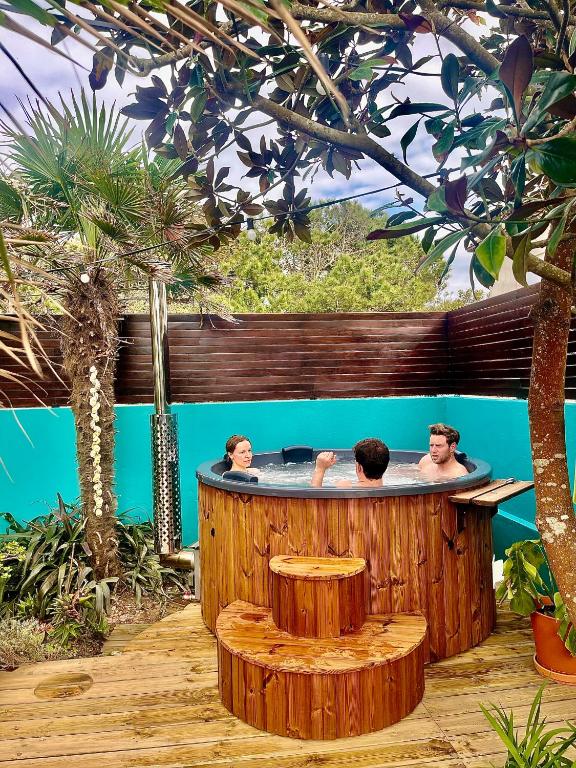two people in a hot tub on a deck at Ticket2Surf in Palheiros da Tocha