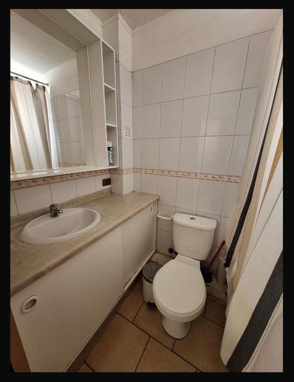 a bathroom with a toilet and a sink at Departamento COPAYAPU in El Cerrillo