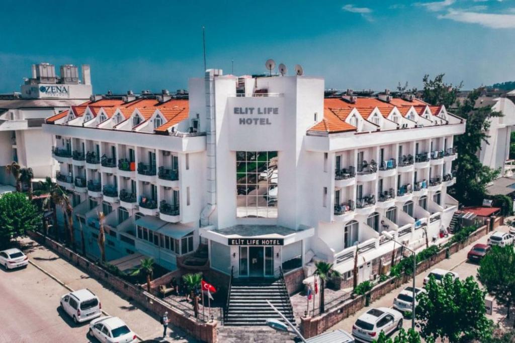 a large white building with a sign on it at Elit Life Otel - All Inclusive in Kemer
