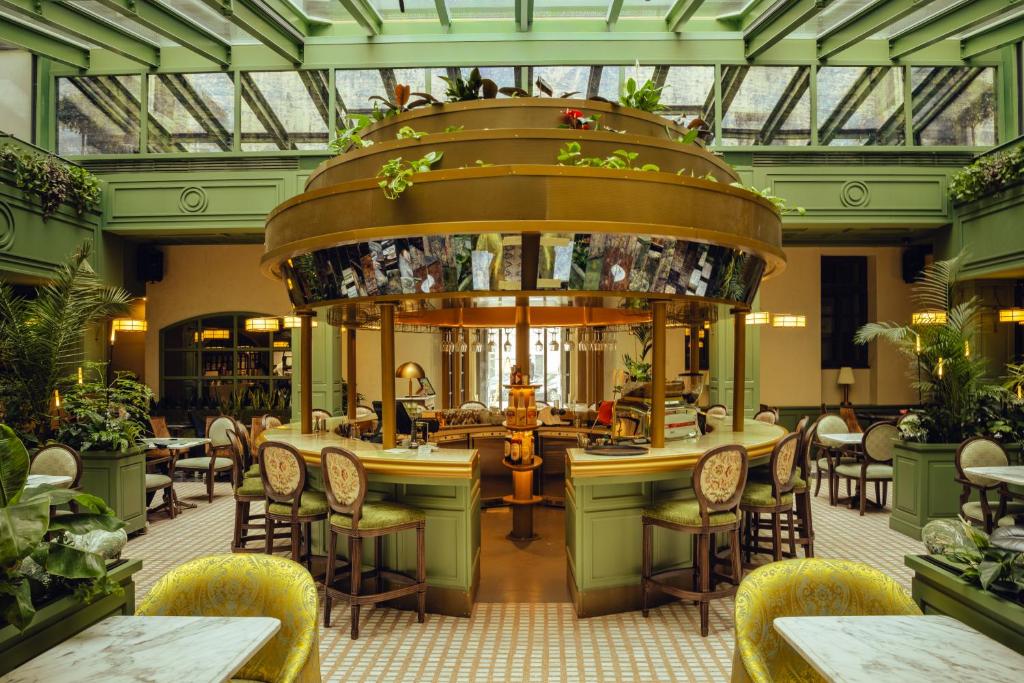 a restaurant with a bunch of chairs and tables at Wonder - The Luxury Boutique Hotel in Budapest