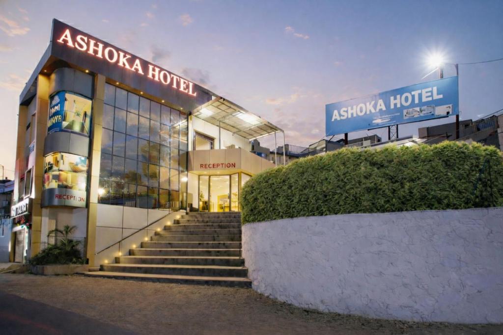 a building with stairs in front of aania hotel at Hotel Ashoka Mountabu in Mount Ābu