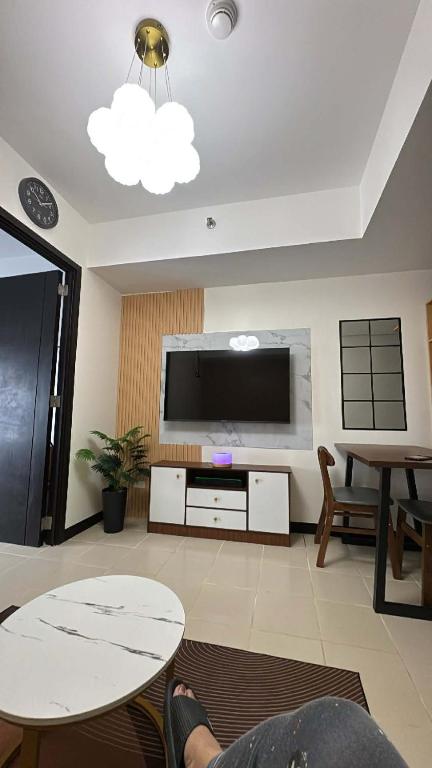 a living room with a large flat screen tv at JI Homestaycation in Manila