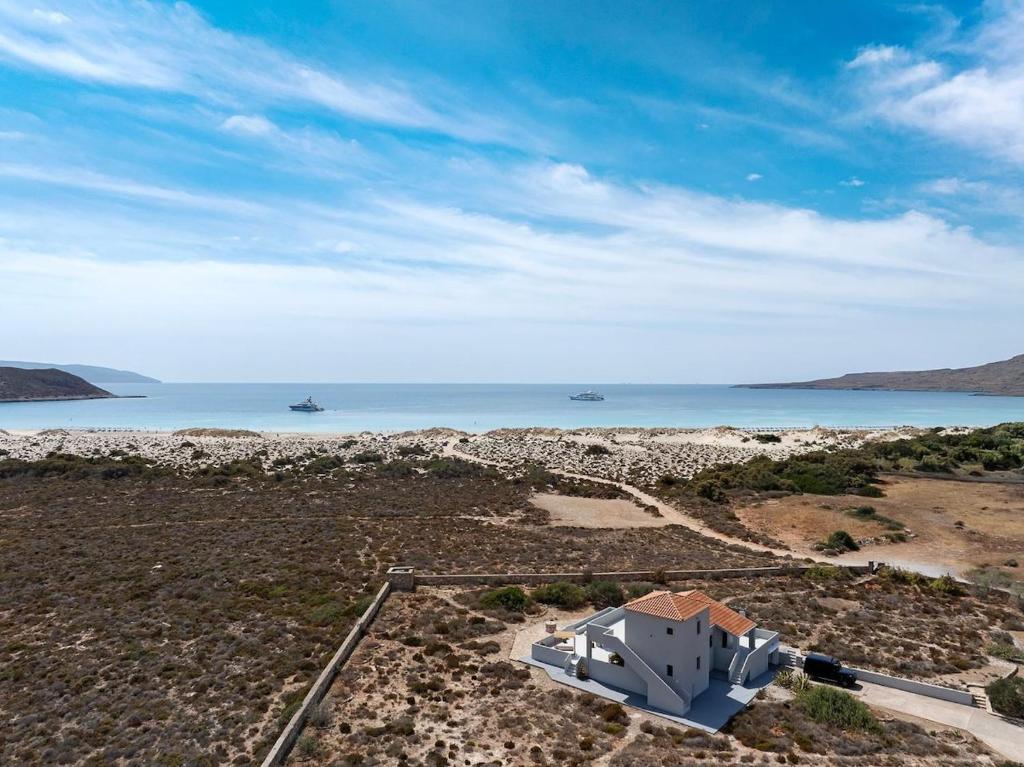 an aerial view of a house and the ocean at Ammos Boutique Villa in Elafonisos