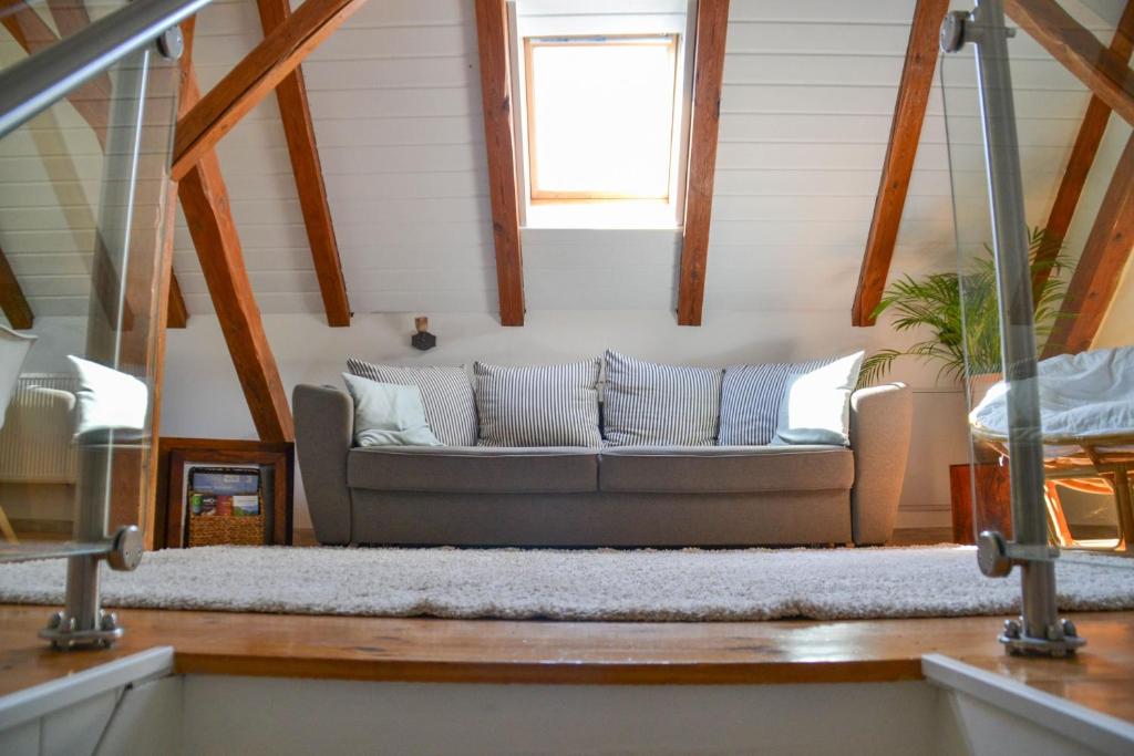 a living room with a couch and a window at Ferienwohnung "ZU HAUSE" in Guben