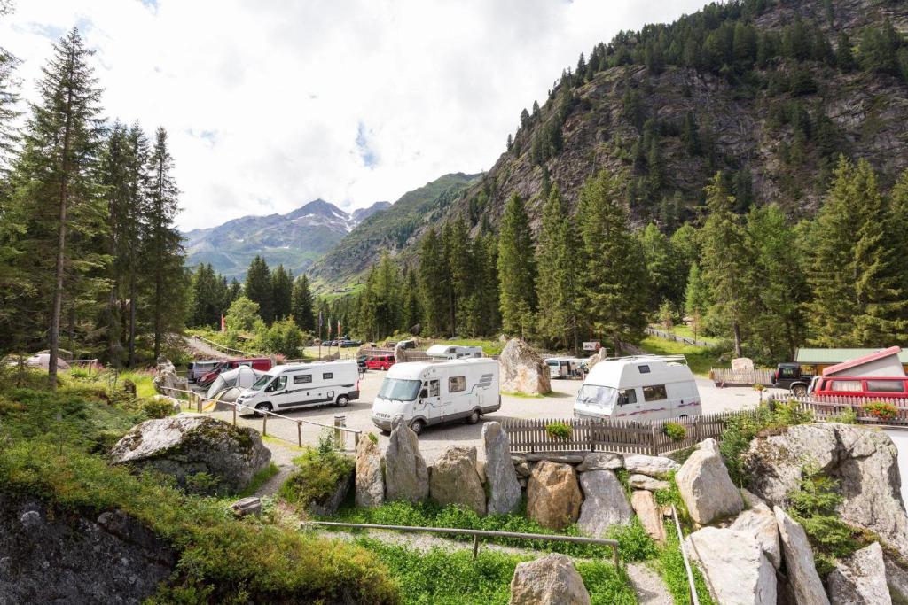 a group of vehicles parked in a parking lot at Camping Bergkristall in Moso