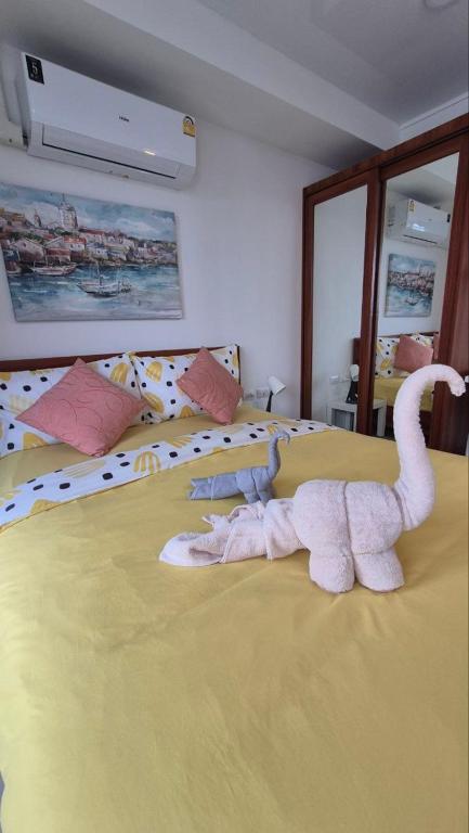 a bedroom with a bed with a towel animal on it at PB329 Phuket's best oceanfront studio in Ban Mai Salae