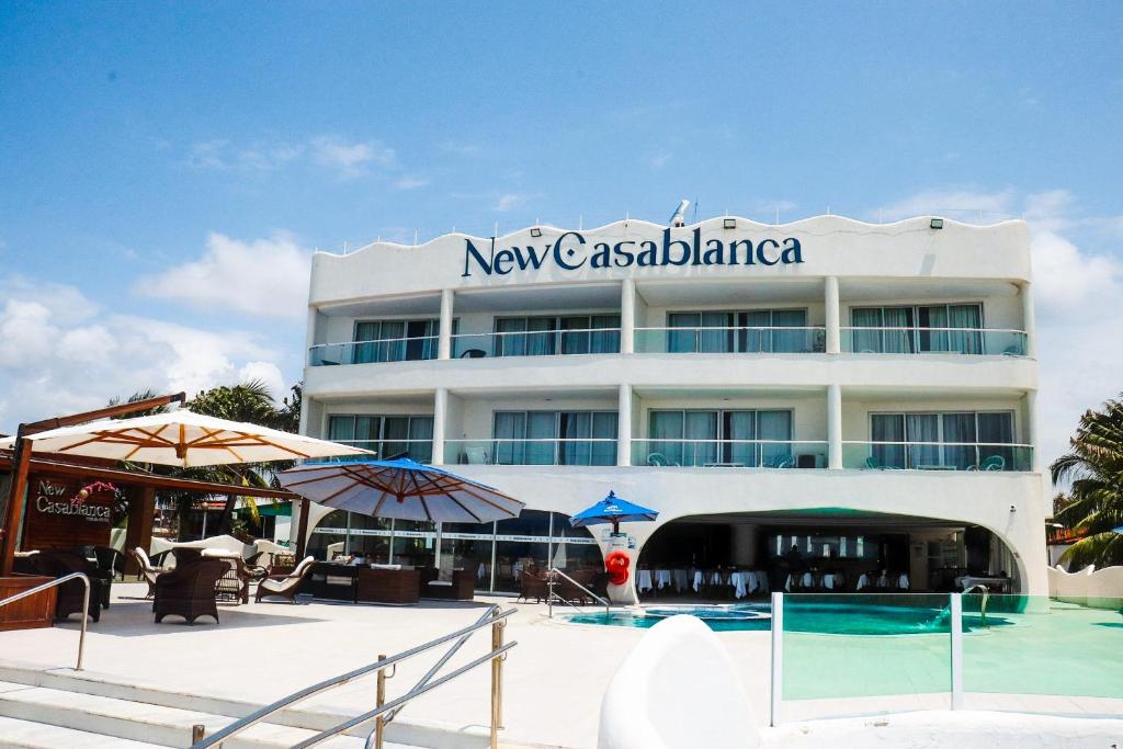 a building with a swimming pool in front of it at New Casablanca Praia Hotel in Paulista