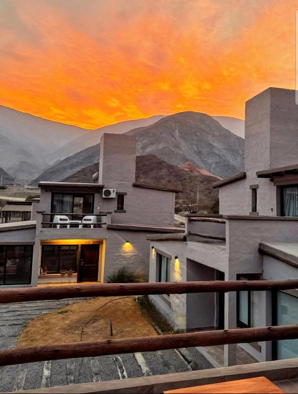 a building with a sunset in the background at Möller Masi in Purmamarca