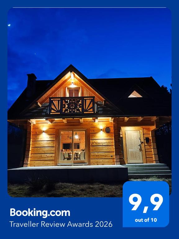 a house with lights on the front of it at zDrzewaDom in Skrzydlna