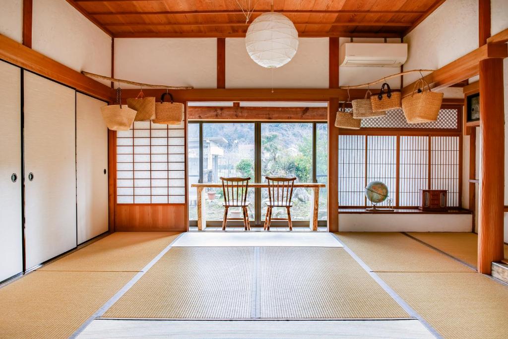 a living room with a table and chairs in it at Mountain Home - One Hour From Osaka in Uda