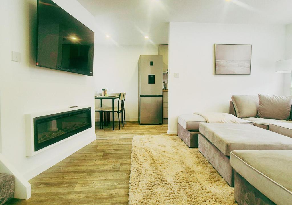 a living room with a couch and a fireplace at Spacious & Luxury 2BR Flat in Calverton in Calverton