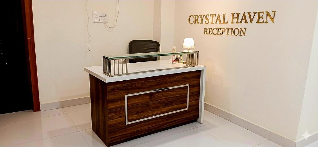 a dressing room with a vanity with a mirror at Hotel Crystal Haven in New Delhi