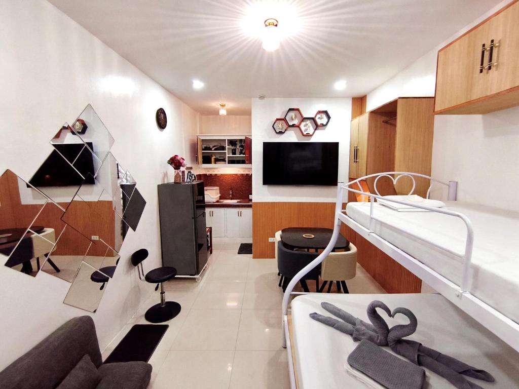 a hospital room with a bed and a kitchen at SNOW Studio Apartment - Near Clark International Airport in Mabalacat
