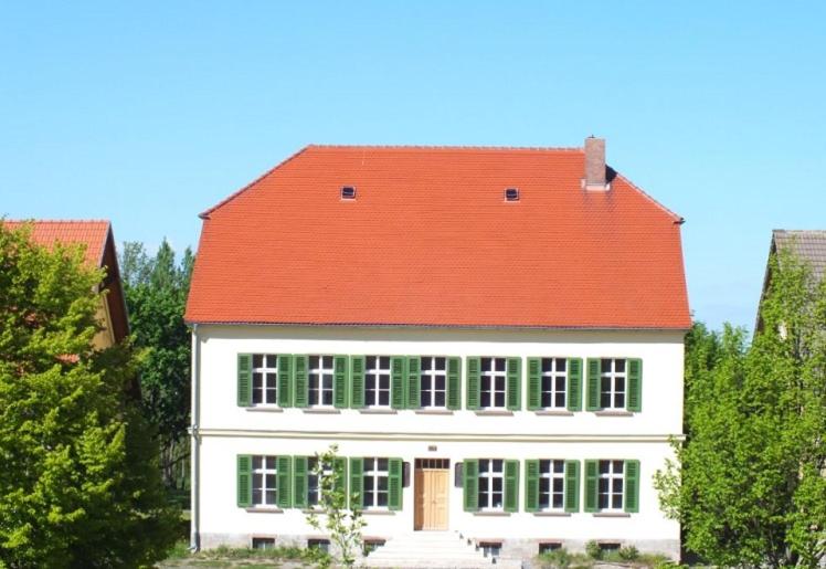 a large white house with a red roof at Rittergut Endorf in Endorf