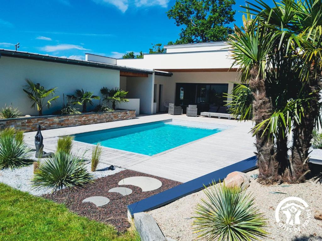 a swimming pool in the backyard of a house at Villa des Oliviers in Flavin