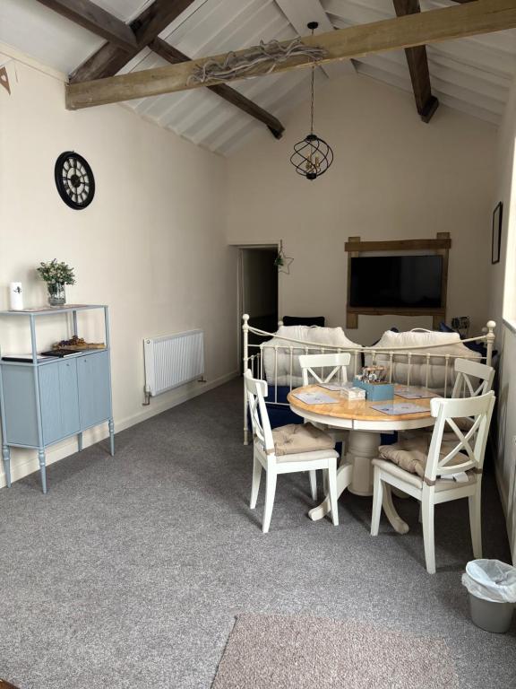 a room with two bunk beds and a table and chairs at The old surgery in Rhymney