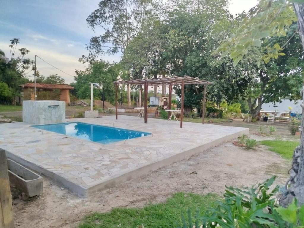 a swimming pool with a gazebo in a yard at Complete Chácara Pool, WiFi 5min Thermas in São Pedro