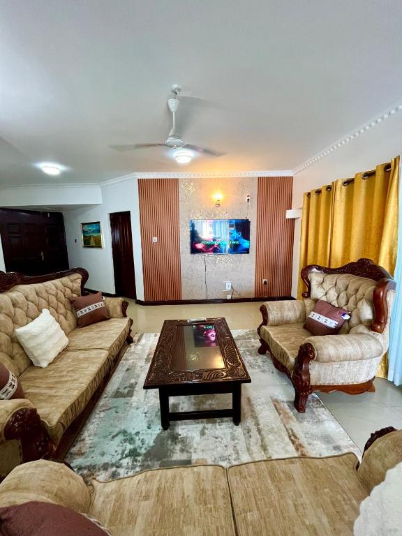 a living room with couches and a coffee table at The Initial Residence in Mombasa
