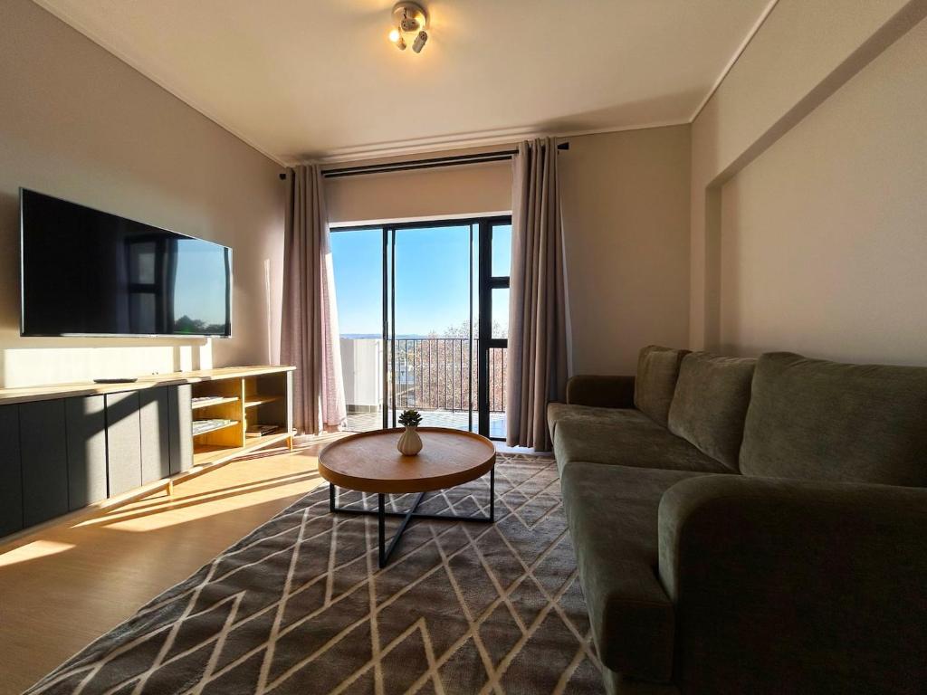 a living room with a couch and a table at 95 Yang Suite A in Johannesburg
