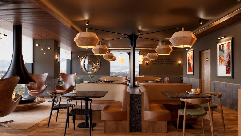 a restaurant with tables and chairs and a bar at B&B HOTEL Covilhã in Covilhã