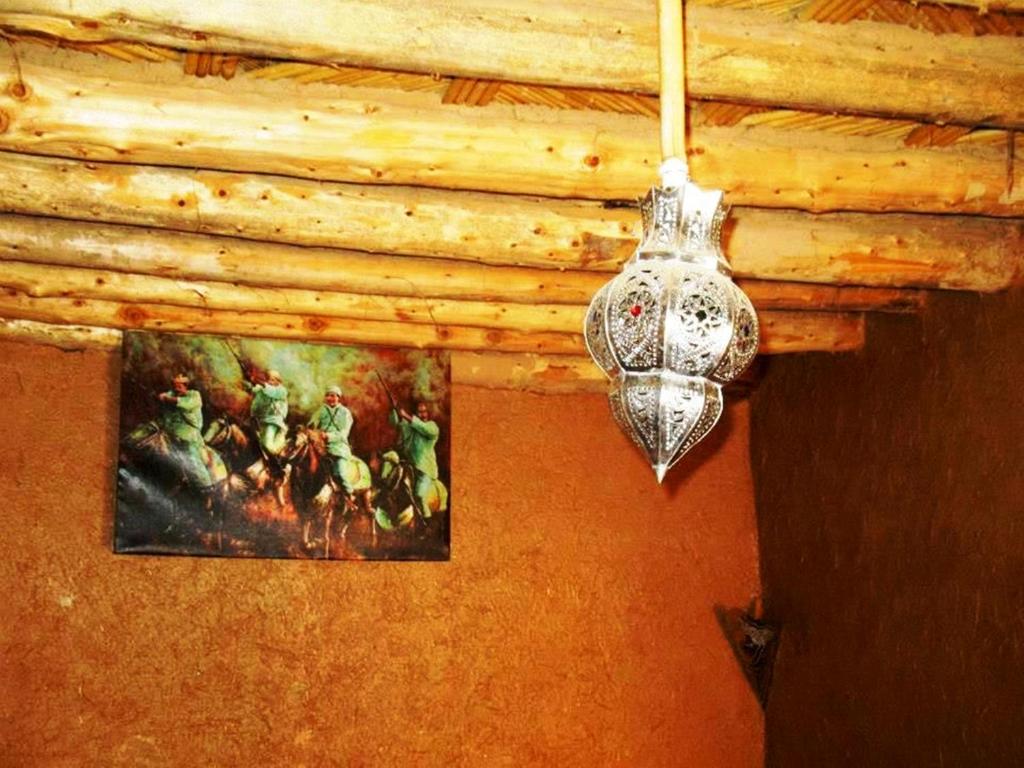 a chandelier hanging from a ceiling with a picture at Tarmguist in Tighmert