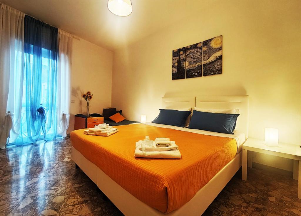 a bedroom with a large bed with towels on it at Klimt-Van Gogh-Dolci Impressioni in Matera