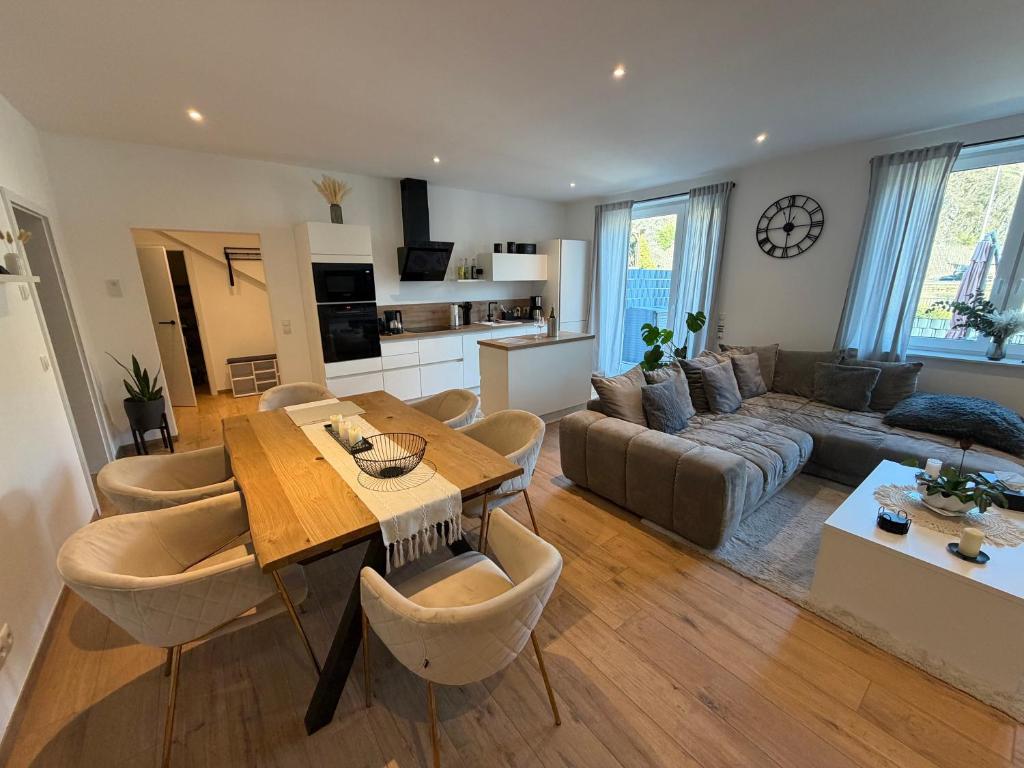 a living room with a table and a couch at Ferienwohnung Schöne Aussicht in Löf