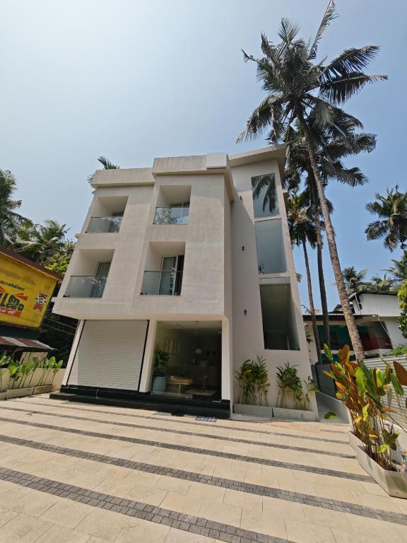 a building with a palm tree in front of it at The Zen Retreat in Kozhikode