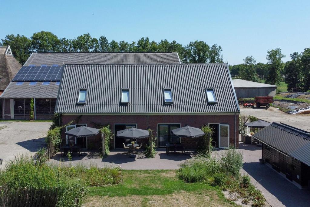 an aerial view of a house with solar panels on it at Hoeve Koning Willem III in Frederiksoord