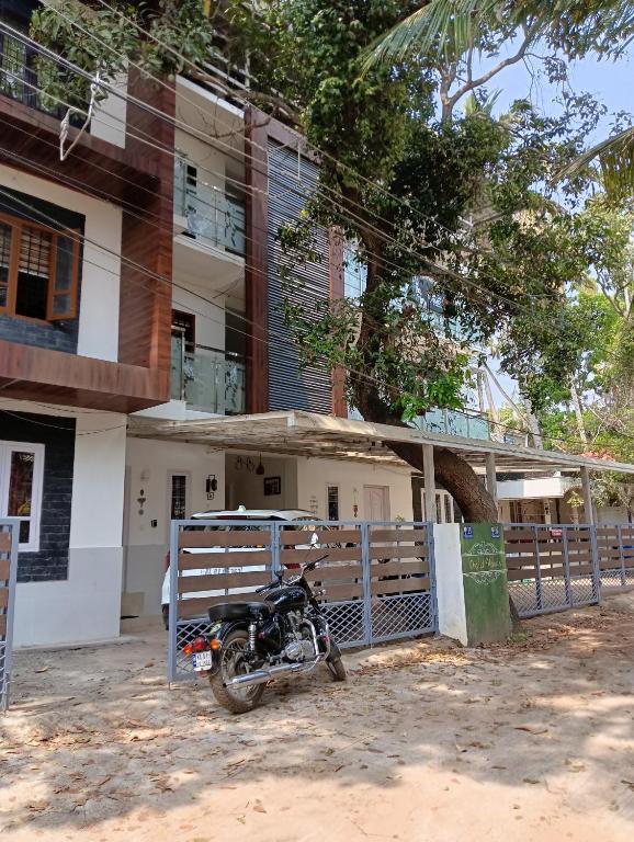 a motorcycle parked in front of a building at Orchid Woods Garden in Trivandrum