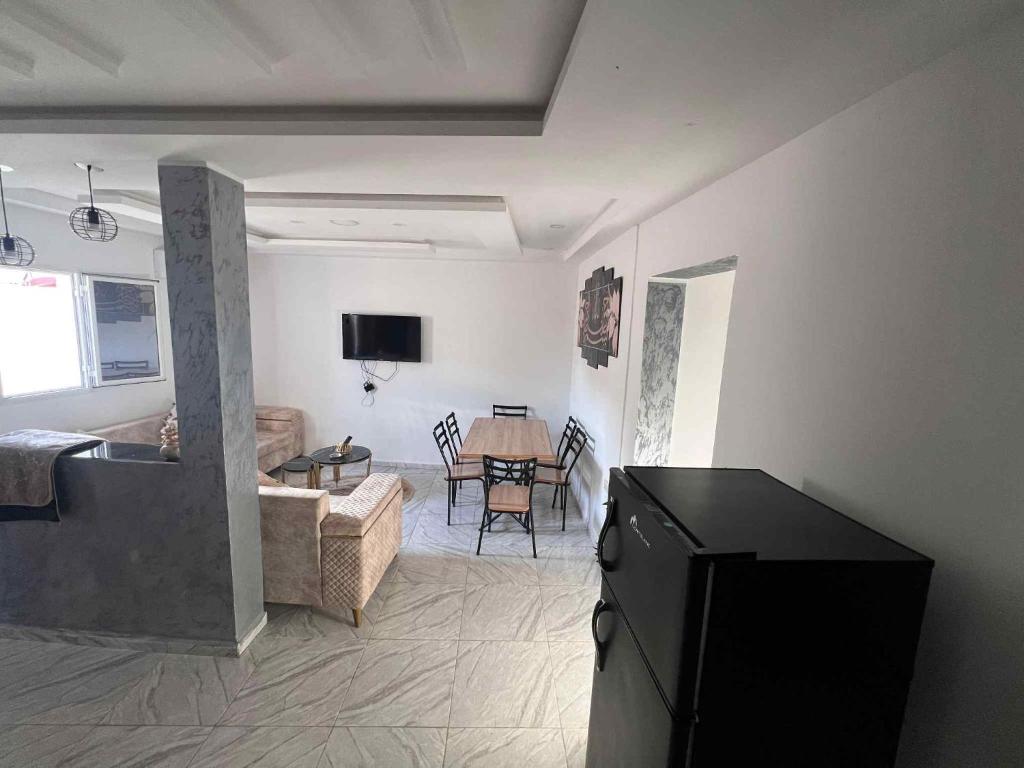 a living room with a couch and a table at Assef home in Midoun