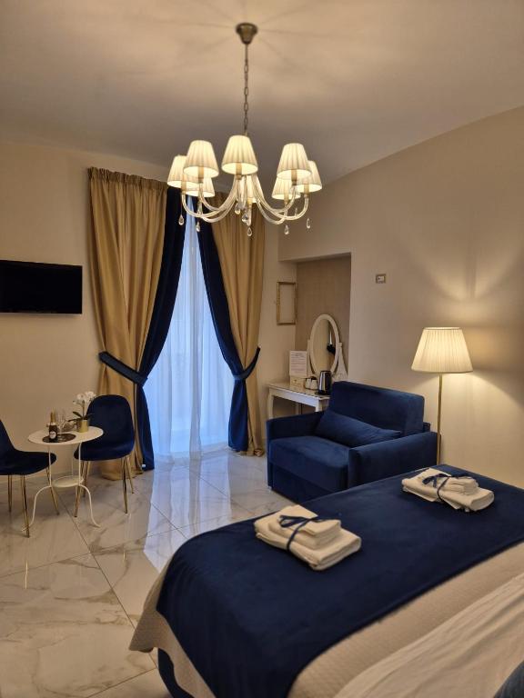a bedroom with a blue bed and a blue couch at Napoli Sogno Infinito in Naples