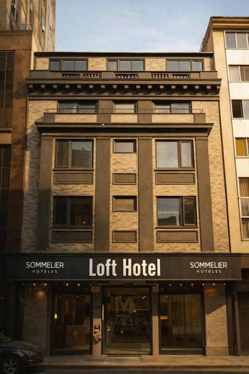 a building with a lot hotel on a street at LOFT Hotel by Sommelier Hoteles in Santiago