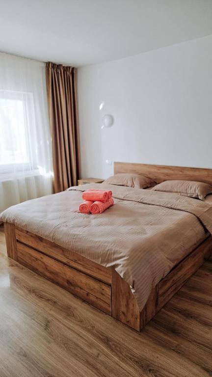 a bed with two red towels on top of it at Cosy apart 3 Fagaras in Făgăraş