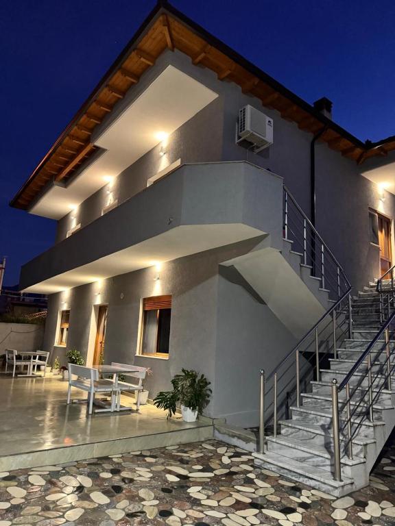 a house with stairs and a table and a patio at Diar Sea House in Orikum