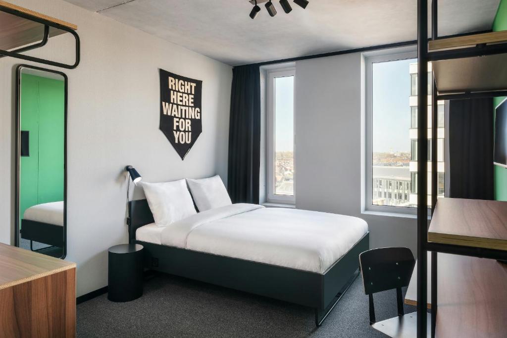 a bedroom with a bed and a bunk bed at The Social Hub Delft in Delft
